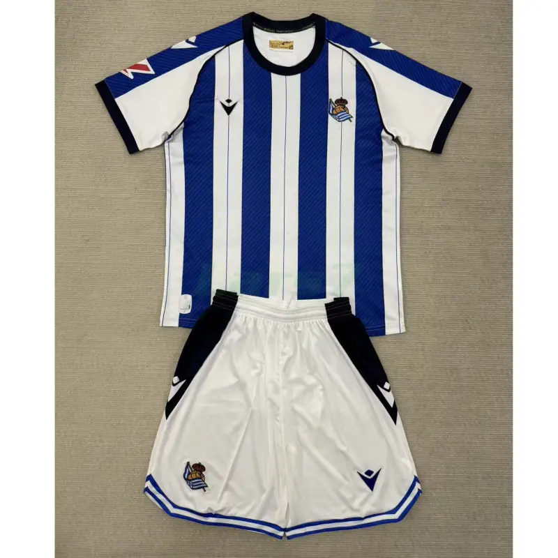 Camiseta Real Sociedad 1ª Equipación 2025/2026 Azul/Blanco Niño Kit con Parche La Liga